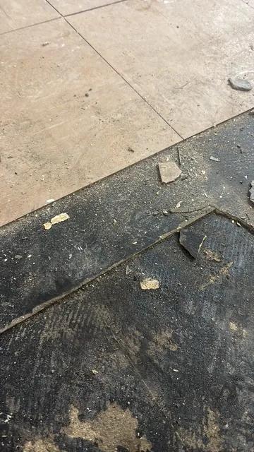 Black bitumen mastic floor removal in a NW2 flat
